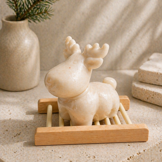 Decorative raindeer soap on a wooden stand with a vase in the background