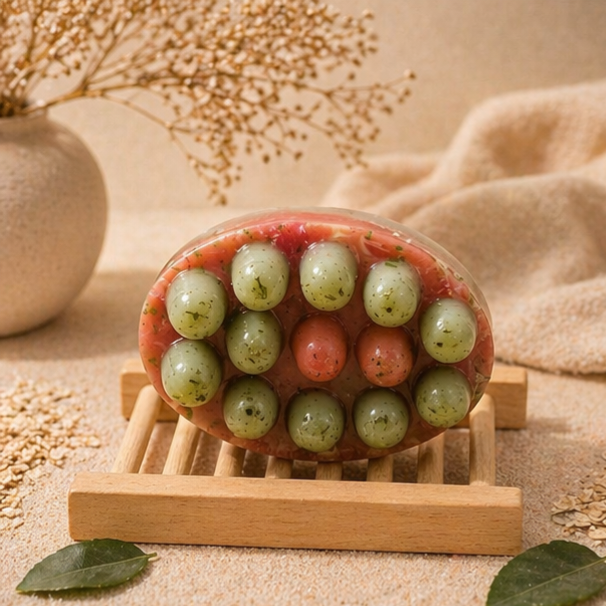 Decorative soap with grape design on a wooden stand against a neutral background